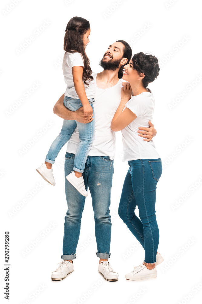 happy latin man holding in arms cute daughter while standing with attractive wife isolated on white happy latin man holding in arms cute daughter while standing with attractive wife isolated on white