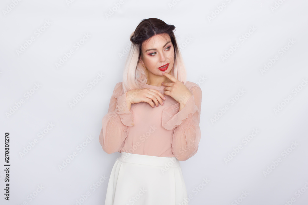 Romantic portrait of blonde woman in light pink blouse and white skirt Romantic portrait of blonde woman in light pink blouse and white skirt