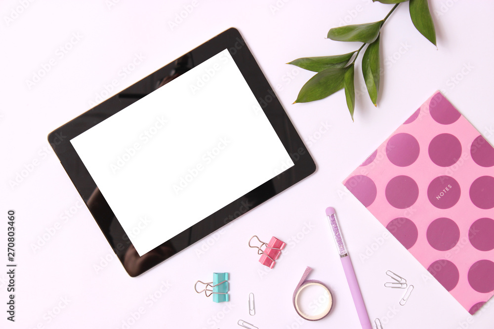 Modern digital tablet and school stationery on a colored background top view. Kontpt back to school. Place for text. Modern digital tablet and school stationery on a colored background top view. Kontpt back to school. Place for text.