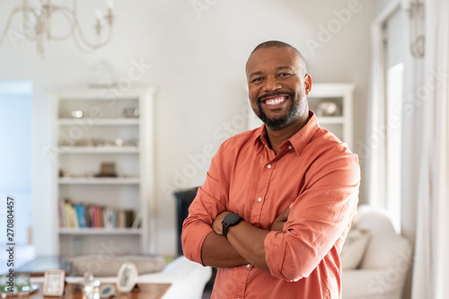 Mature black man with crossed arms looking at camera photo