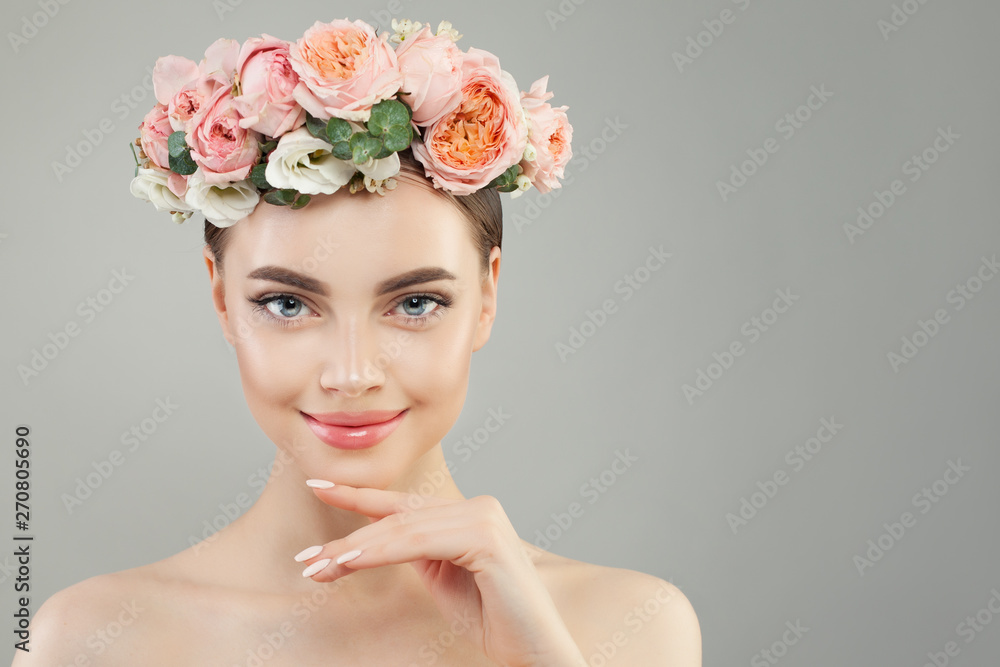 Pretty spa woman with clear skin and tender rose flowers portrait