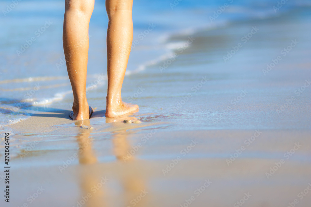 Texture background Footprints of human feet on the sand near the water on the beach Texture background Footprints of human feet on the sand near the water on the beach