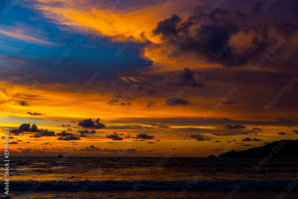 Beautiful color of nature orange and blue sky touch the edge of the sea.