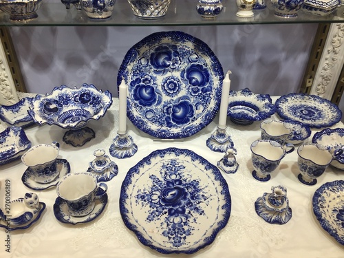 Blue Porcelain crockery for sale. Selection of plates, bowls and porcelain for sale in the shop. blue porcelain utensils with plates and cups and bowls on display at street market.