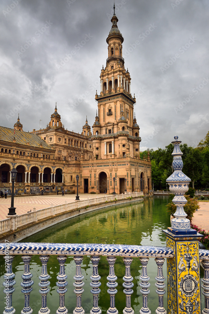 South tower from a bridge with painted ceramic over the canal at Plaza de Espana Seville Spain