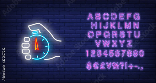 Stopwatch in hand neon sign. Glowing neon hand holding timer on dark blue brick background. Vector illustration for games, completions