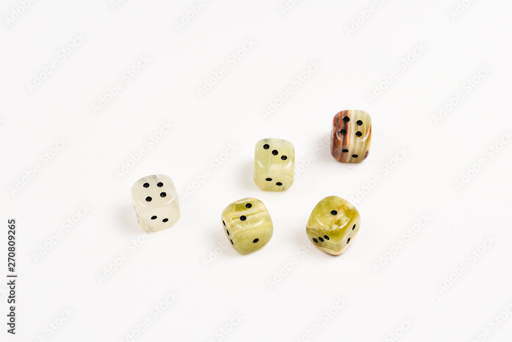 Dices made of natural stone on a white background. Copy space. Gaming. Dices made of natural stone on a white background. Copy space. Gaming.