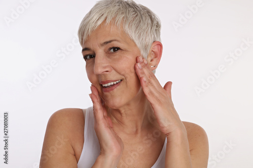 Happy Smiling Mature Woman Portrait on white background. Older skin care  Anti-aging and Beauty concept.