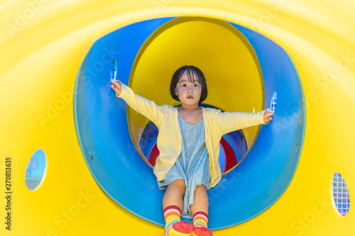 Asian Chinese little girl playing in the tunnel