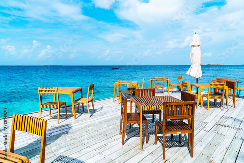 Fototapeta Naklejka Na Ścianę i Meble -  wood table and chair with sea view background in Maldives