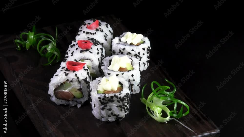 Japanese traditional rolls with seafood and fish, vegetables, on a black background. Japanese traditional rolls with seafood and fish, vegetables, on a black background.