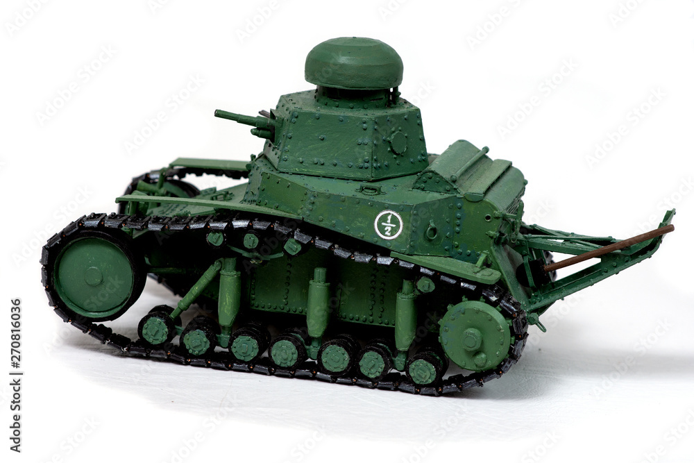 Model of the old Soviet tank of paper on a white background. Look in the back. The concept of manual labor, Hobbies. Model of the old Soviet tank of paper on a white background. Look in the back. The concept of manual labor, Hobbies.