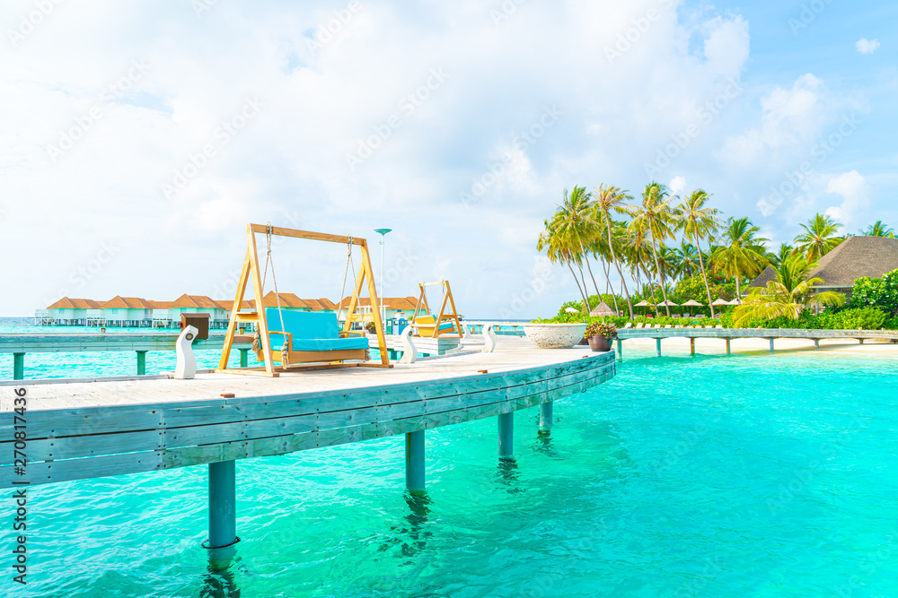 sofa swing with tropical Maldives resort and sea background