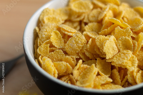 corn flakes on wooden table at morning 
