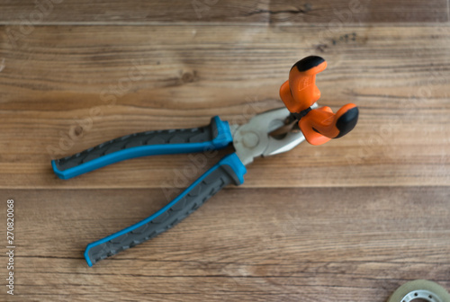 pliers on a wooden background