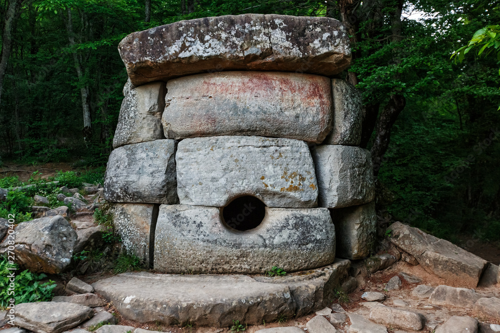 Fototapeta premium Ancient round compound dolmen in the valley of the river Jean, Monument of archeology megalithic structure.