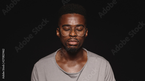African man with eyes closed