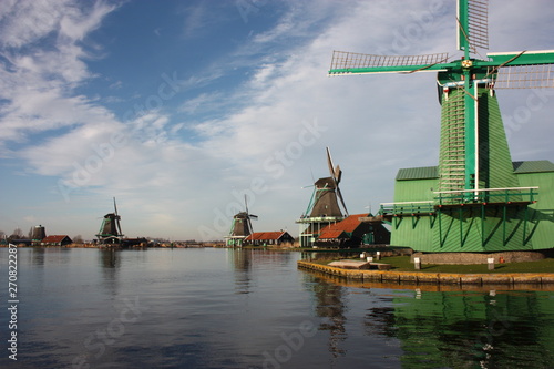 where to go and what to do in amsterdam, a tourist village with a view of the typical holland windmills built of wood