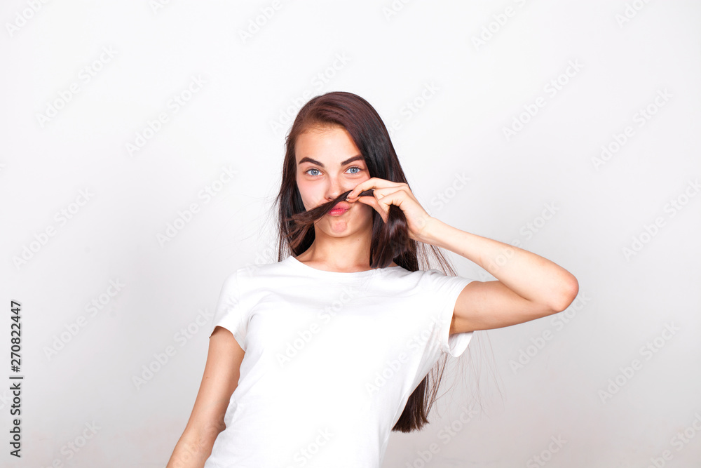 Young beautiful woman with a mustache from their hair Young beautiful woman with a mustache from their hair