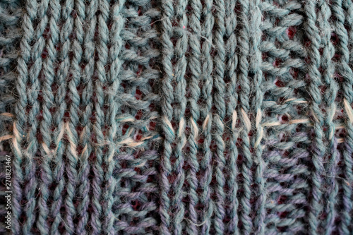 knitted fabric handmade purple-turquoise with a strip of fragment macro © Vitalii