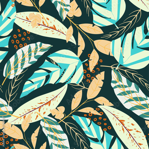 Bright seamless pattern with tropical leaves and plants on a dark green background. Vector design. Jungle print. Textiles and printing.