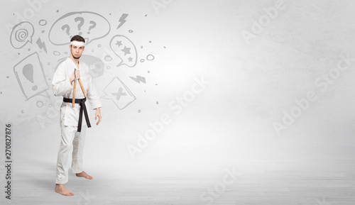 Young kung-fu trainer fighting with doodled symbols concept 