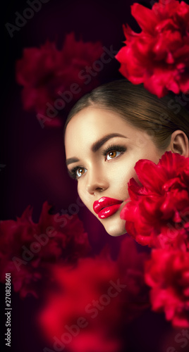 Beautiful girl with red peony flowers portrait. Beauty fashion model woman face closeup. 