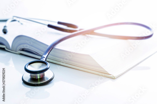 stethoscope and clipboard with paper and pen