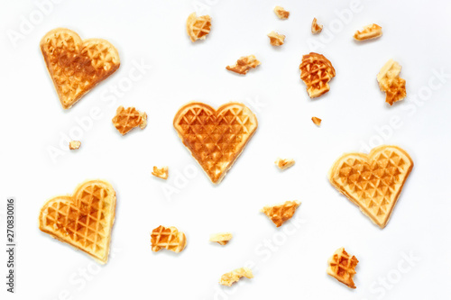 Quadro em tela Background from Heart shaped waffles and pieces of waffle on white backdrop