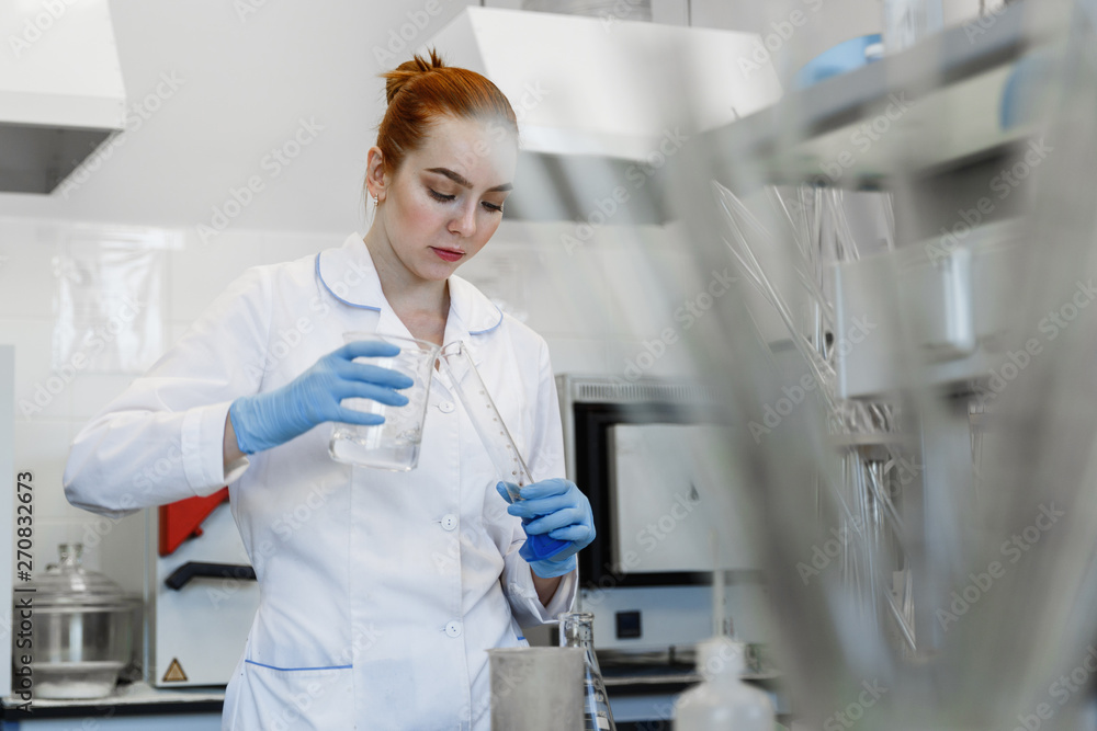 red-haired woman works in the medical laboratory red-haired woman works in the medical laboratory