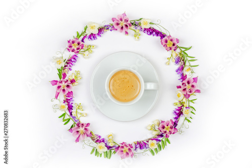 Cup of cappuccino coffee in a round vintage floral frame of Jasmine flowers and wildflowers on a white background top view close-up  flat lay