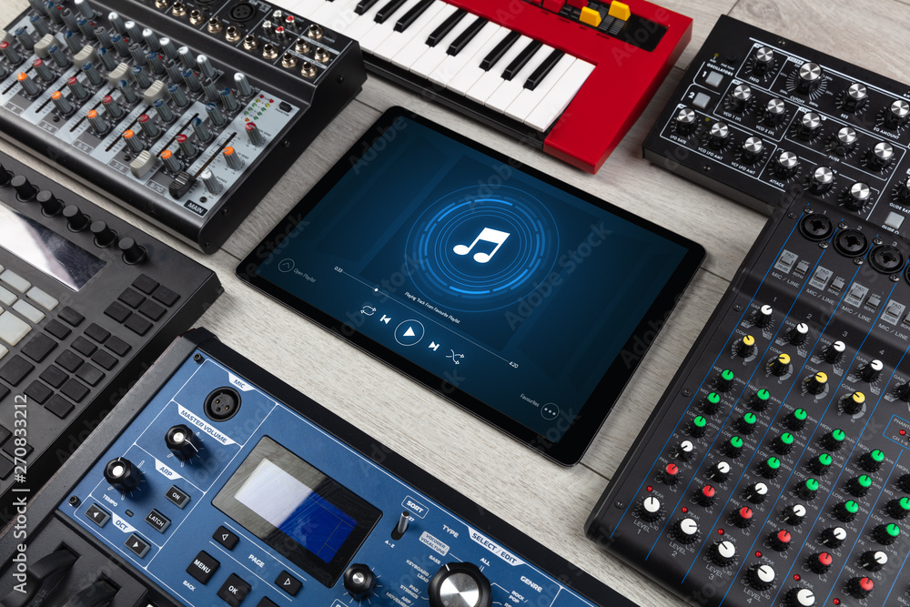 Playing song on tablet with electronic music instruments around
Playing song on tablet with electronic music instruments around