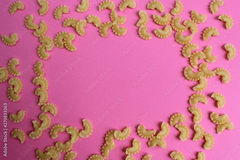 texture of pasta in the form of an arc on a pink background texture of pasta in the form of an arc on a pink background
