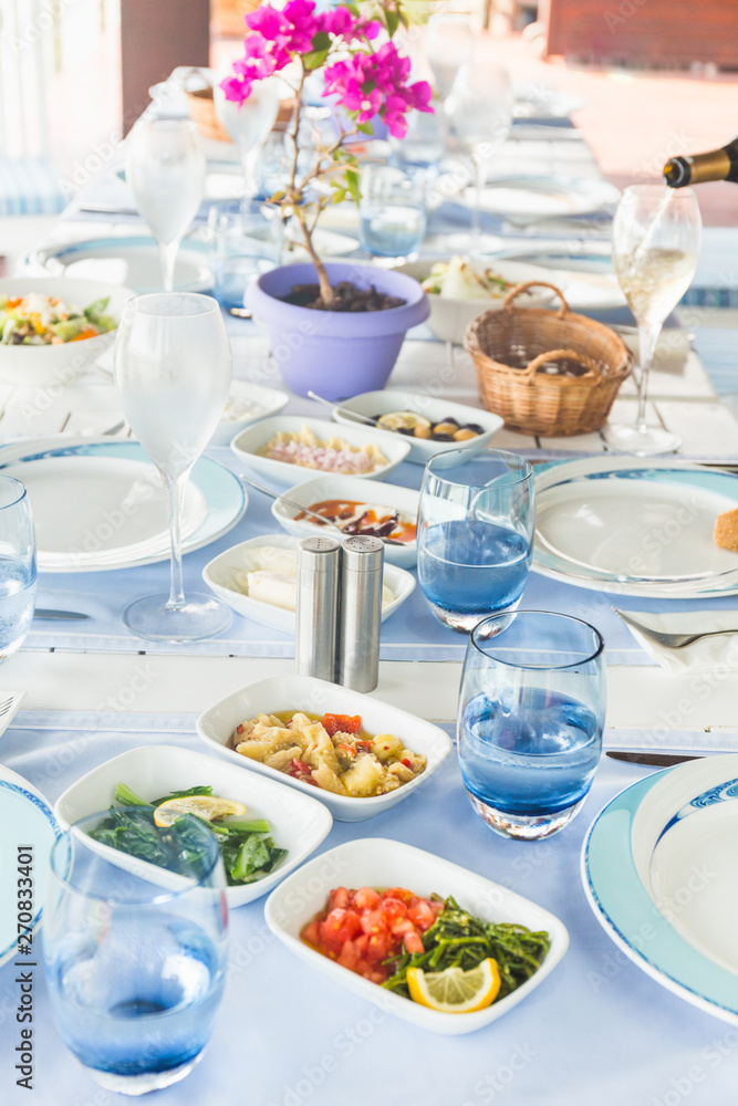 Varioius meze starters in an outdoor greek restaurant. Healthy vegetarian snacks. Local mediterranean cuisine. Top view Varioius meze starters in an outdoor greek restaurant. Healthy vegetarian snacks. Local mediterranean cuisine. Top view