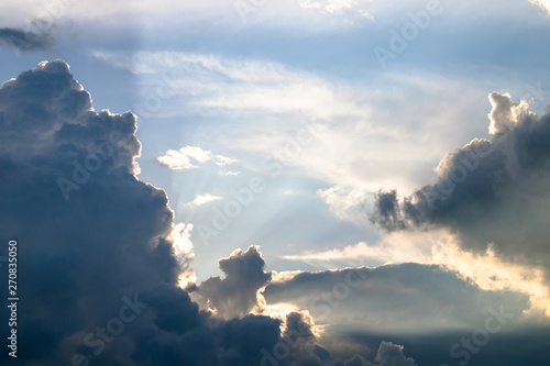 Cumulus sunset clouds with sun setting down