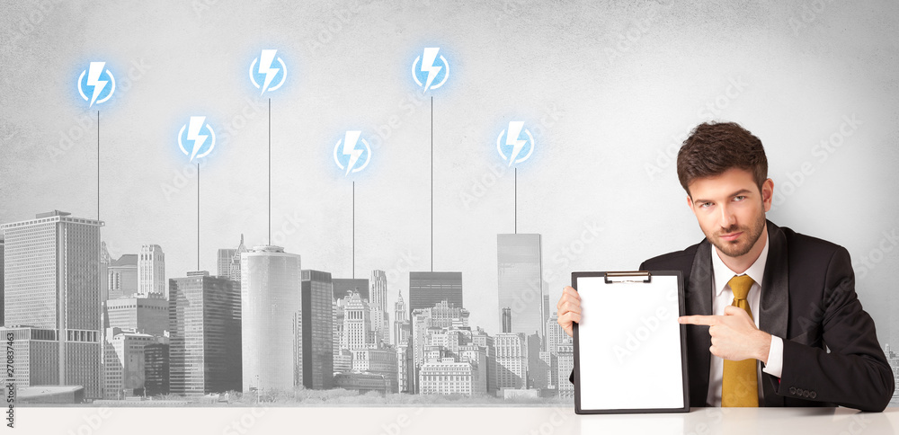 Announcer sitting at desk presenting the city energy consumption
