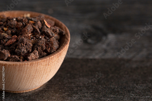 Bowl of Myrrh on a Dark Wood Table