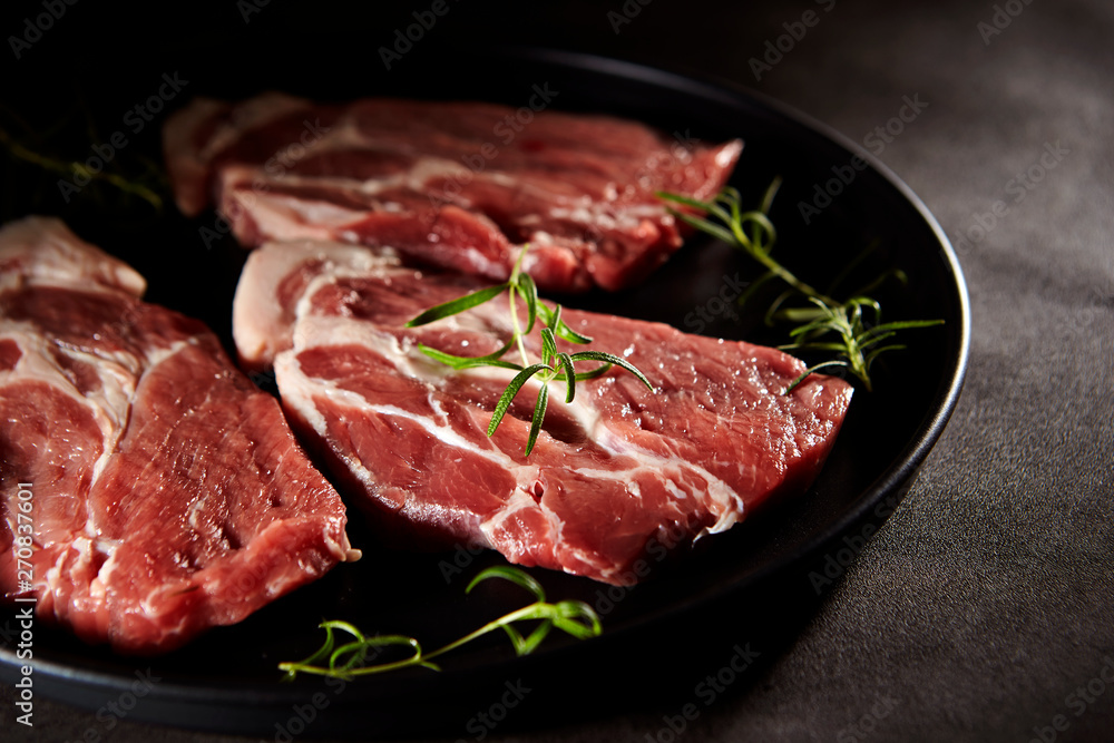 Fresh raw steak meat with rosemary
