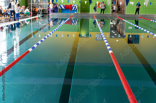 Swimming pool with blue and transparent water. Competition at a sports event.