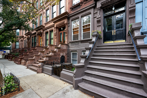 a view of a row of historic brownstones in an iconic neighborhood of Manhattan  New York City