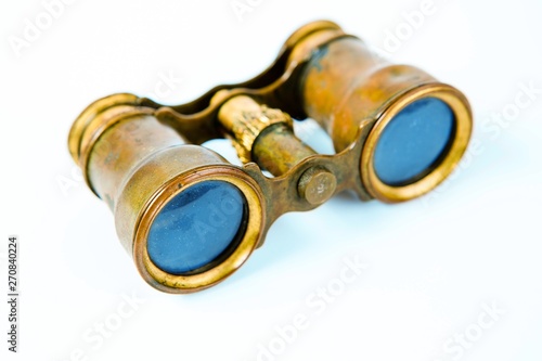 Vintage brass binoculars on white background