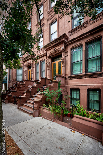 a view of a row of historic brownstones in an iconic neighborhood of Manhattan, New York City © goodmanphoto