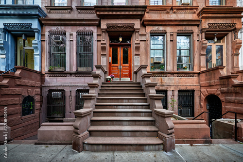 a view of a row of historic brownstones in an iconic neighborhood of Manhattan, New York City © goodmanphoto