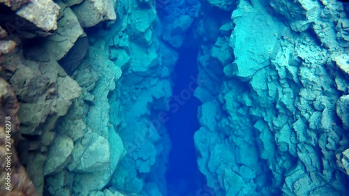 beautiful clear silfra in iceland lagoon with clear blue waters and rocks