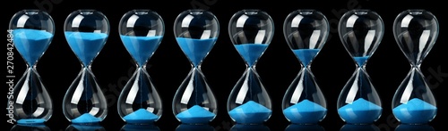 Tableau sur toile Collection of hourglasses with blue sand showing the passage of time