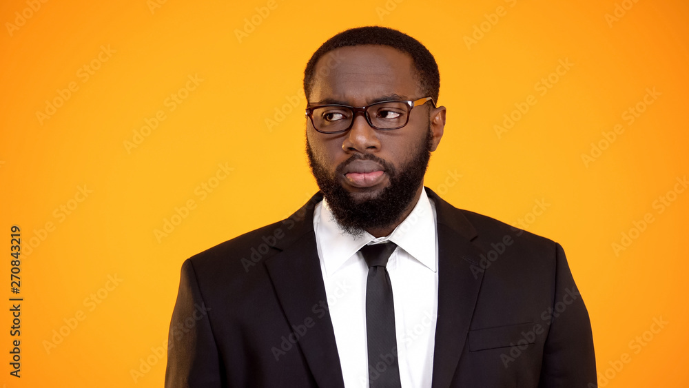African-american male in business suit looking aside, eyesight and ophthalmology African-american male in business suit looking aside, eyesight and ophthalmology