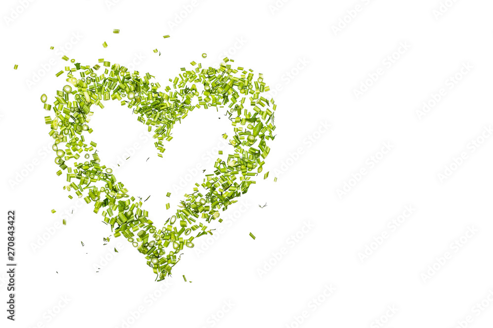 a green heart of chopped parsley and dill on white background