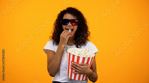 Φωτογραφία Afro-American female in 3d glasses eating popcorn and watching comedy show