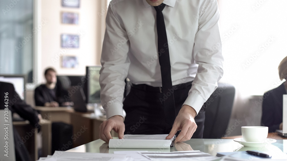 Male manager reading contract, preparing documents for meeting, planning agenda Male manager reading contract, preparing documents for meeting, planning agenda