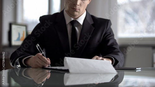 Serious boss signing agreement, important contract for company restructuring photo